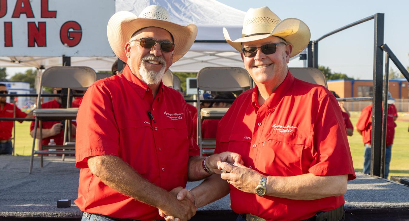 Ben Franklin, left, president of the Lyntegar EC Board of Directors, presents CEO Greg Henley with his 40-year service award at the 87th annual meeting in August. 